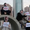 Activists stage a protest in support of Huang Xueqin and Wang Jianbing